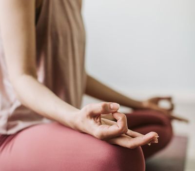 Close-up of hands in a meditative pose, showing concentration.